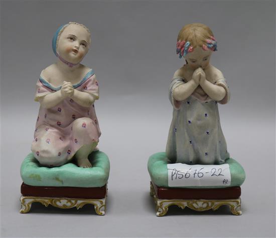 A pair of bisque figures of praying children height 16cm